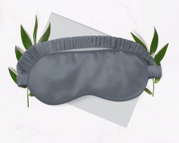 Grey silk sleep mask with soft, comfortable design.