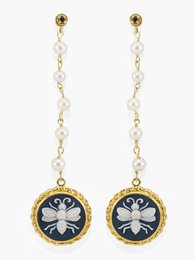 Elegant gold-tone dangle earrings featuring a cameo-style bee design with pearl accents. Ideal for formal or casual wear.