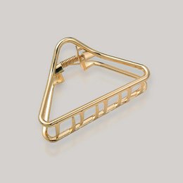  Gold-toned hair clip with a triangular shape and decorative grooves. Suitable for holding back or styling hair.