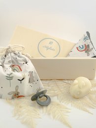 Rectangular pencil box with baby-themed design, including a pacifier and soft plush toy. Neutral colors of white, gray, and beige. Suitable for newborn or infant gift.
