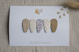 Colorful floral hair clips in small, medium, and large sizes. Made with a mix of materials including patterned fabric and gold accents.