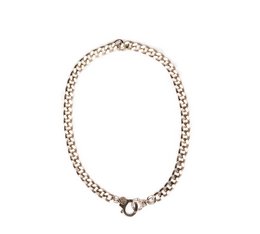 Silver-toned charm necklace with a circular charm pendant.