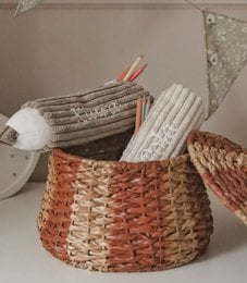 Corduroy pencil case in the shape of a crayon with child's name, made of woven material in brown and white colors.