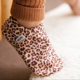 Leopard print baby shoes with soft, plush material and slip-on design.