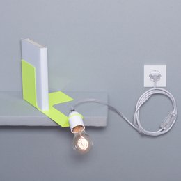 A white and green bookend lamp with a single light bulb, designed for wall mounting.