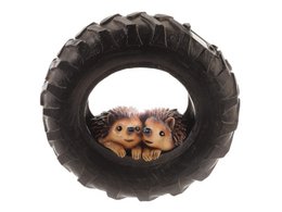 A round, black tire-shaped object with two small hedgehog figures peeking out from the center. The tire appears to be made of a durable, textured material, likely for outdoor use.