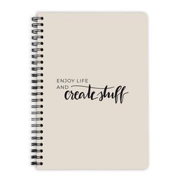 A5-sized spiral-bound notebook with 60 sheets, featuring the text "Enjoy life, create stuff" printed on the cover.