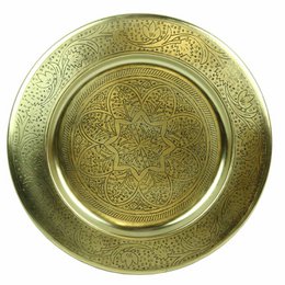 A round, gold-colored serving tray with an intricate, ornate pattern etched into the surface. The tray appears to be made of metal and has a decorative, traditional Middle Eastern or Oriental design.