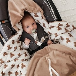 Soft, cozy baby car seat swaddle/blanket in a spring/summer edition featuring a teddy bear print. Made of comfortable, breathable materials to keep your little one snug and secure.