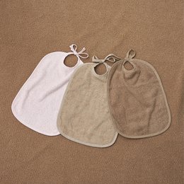 Bib with tie closure, terry cloth Sand