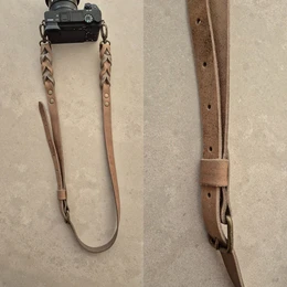Leather camera belt in stone color with silver and oud messing variants. Durable and stylish accessory for photographers.
