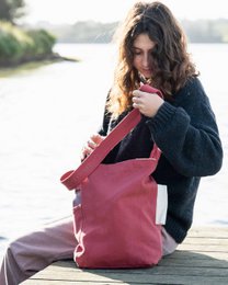Dusty cedar canvas shoulder bag with a cozy black fuzzy jacket.
