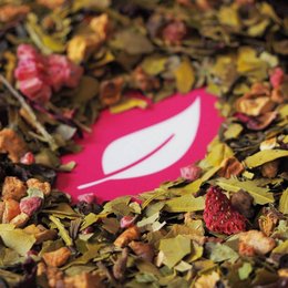 Organic Raspberry Strawberry Yerba Mate tea in various packaging sizes, including pouches and metal boxes. The tea contains a blend of organic raspberry, strawberry, and yerba mate.