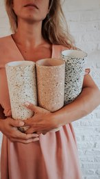 Polly Vase - Siena Collection. Tall cylindrical vases, speckled terrazzo pattern, cream beige neutral color, modern minimalist style, ceramic material.