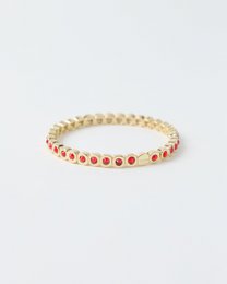 Red and gold beaded bracelet, elastic stretch band, round gemstone beads, cherry red stones, gold-tone metal spacers.