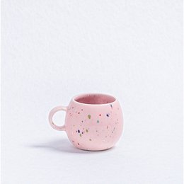 Pink speckled ceramic mug with saucer, perfect for espresso or coffee.