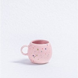 Pink speckled ceramic mug with saucer, perfect for espresso or coffee.