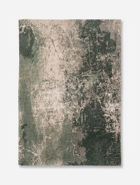 Large, round, green area rug made of natural fibers with a distressed, vintage-inspired design.