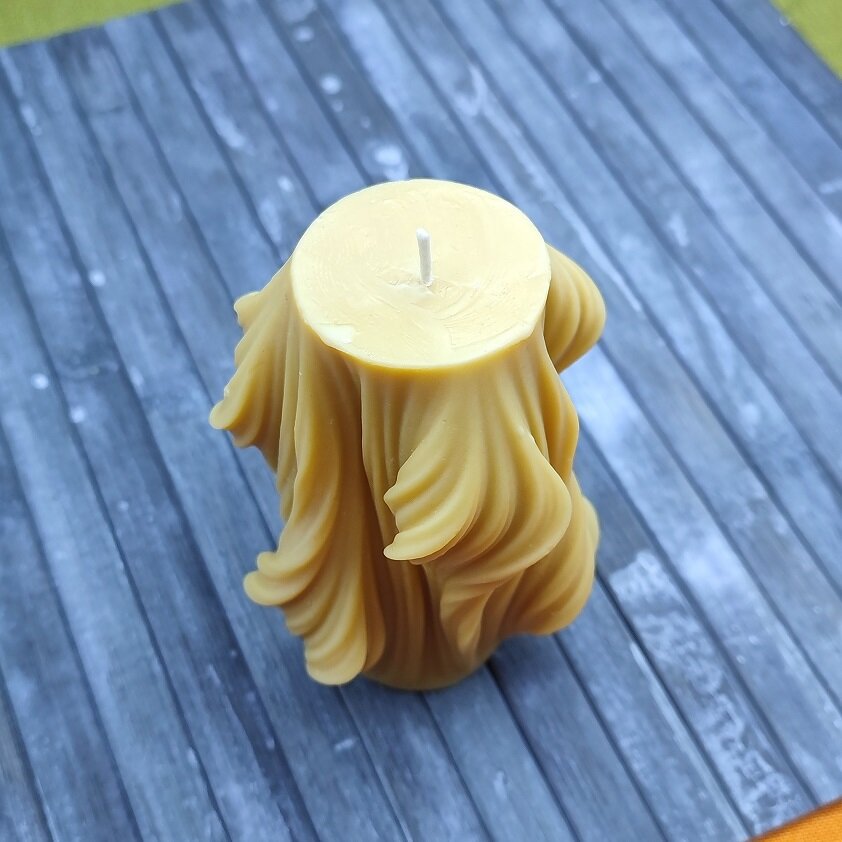 Ona-shaped beeswax and soy candle
