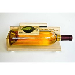 A bottle labeler device with a clear plastic body and a yellow label. The device appears to be designed for labeling bottles or cans.