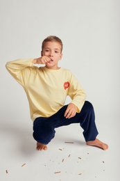 Yellow long-sleeved t-shirt with a red heart graphic print for kids.