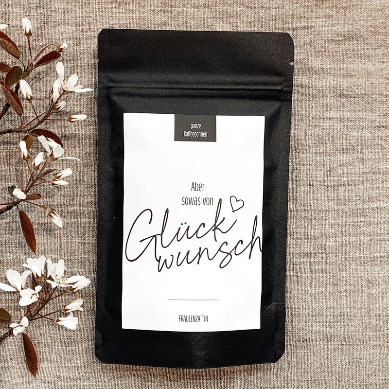 Regalo en grano de café “Sowas” – Bolsa midi negra de 50 g – Felicitaciones por el éxito del recuerdo