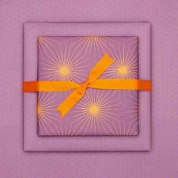 Lila Geschenkpapier mit Sonnensternen, retro Geschenkpapier orange und lila, ideal als Geburtstags- Geschenkpapier Frühling oder Weihnachtsgeschenkpapier
