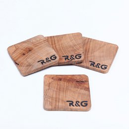 Set of 4 wooden coasters with "R&G" logo, made of natural wood material.