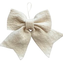 A large, off-white, wool felt bow hanger holder that is handmade in Nepal. The bow has a soft, fluffy texture and is attached to a green crocheted holder that is decorated with ornaments.