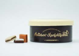 Assorted licorice candies in a round tin container with the brand name "Chateau d'Anglefort" printed on the lid.