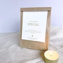 White bath bombs with floral design and "With Love" text on packaging.