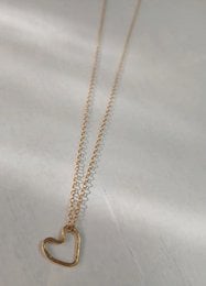 Gold filled and sterling silver heart-shaped pendant necklace with delicate chain.