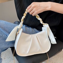 Elegant small shoulder bag with 2 optional carrying handles, made of beige material with a twisted rope strap.