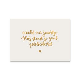 A gold foil-stamped birthday card with a heartfelt message in a cursive font. The card features a simple, elegant design with a warm, celebratory tone.