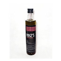 Dark glass bottle, black label with pink checkered pattern, liquid vegetable oil, culinary product