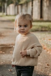 Beige knit sweater for babies, available in sizes 3-6 months to 4 years. Made of soft, warm material perfect for cooler weather.
meta_keywords: baby sweater, knit sweater, beige sweater, baby clothing, toddler clothing