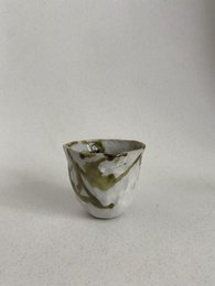 Glossy handmade ceramic cups in a minimalist, modern design. Features a simple, curved shape with a neutral color palette.