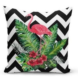 Decorative throw pillow with tropical flamingo and foliage design on a black and white chevron background. Suitable for use in living rooms, bedrooms, or outdoor spaces.