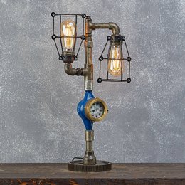 A vintage-inspired table lamp with a unique industrial-style design featuring two lantern-shaped shades and a metal pipe base.