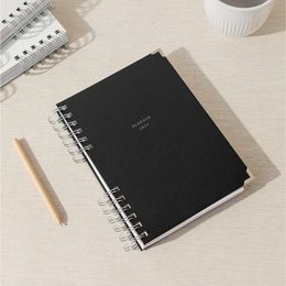 A classic black or arctic grey 2023 planner with a spiral binding and minimalist design, suitable for academic or professional use.