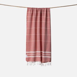 Burnt brick striped hammam towel with white horizontal stripes and fringed edges, lightweight cotton.