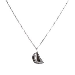 Silver-toned sailing boat charm pendant on a delicate chain necklace.