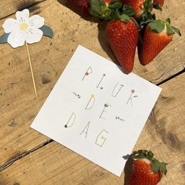 "Thank you card with floral design and strawberries"
The image shows a thank you card with a handwritten message "Thank you" on it. The card is placed on a wooden surface, surrounded by fresh strawberries and a white flower. The overall design and composition suggest this is a thank you card, likely for a special occasion or event.