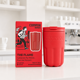 Signal red insulated travel mug, cylindrical shape, modern minimalist design, stainless steel construction, commute coffee cup