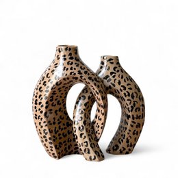  Pair of entwined leopard print vases with a unique, sculptural design.