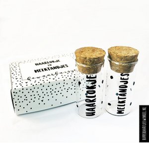Tress and baby teeth tubes in gift packaging