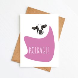 A pink greeting card with a cow illustration and the text "Koerage!" This card is suitable for get well wishes.