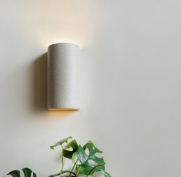 Beige speckled ceramic wall sconce with modern minimalist design, suitable for living room lighting.
