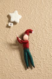  Decorative wand with red and green felt figure and star-shaped ornaments.