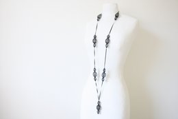 Long black necklace with oval-shaped beads